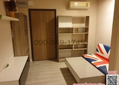 Cozy living room interior with shelving, modern furniture, and air conditioning unit