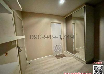 Empty bedroom interior with closet doors and wooden flooring