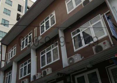 Multi-story residential building with balconies and air conditioning units