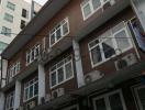 Multi-story residential building with balconies and air conditioning units