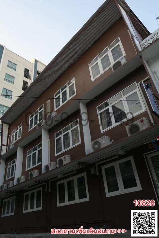 Multi-story residential building with balconies and air conditioning units