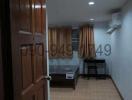 Cozy bedroom with wooden door, tiled flooring, and air conditioning