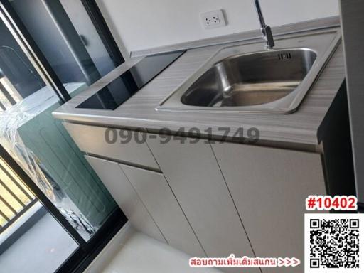 Modern kitchen with sleek countertops and stainless steel sink