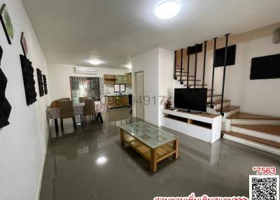 Spacious and well-lit living room with integrated dining area and adjoining kitchen