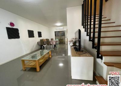 Modern living room interior with dining area and staircase