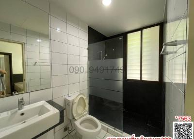 Modern bathroom with shower cabin and ceramic tiles