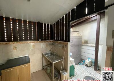 Compact kitchen with stainless steel sink and tiled backsplash