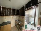 Compact kitchen with stainless steel sink and tiled backsplash