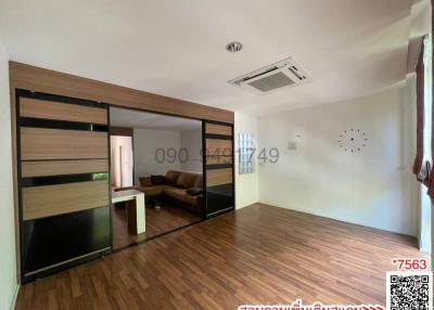 Spacious bedroom with large sliding door wardrobe and hardwood flooring