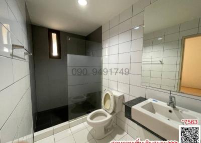 Modern bathroom with white tiles and fixtures