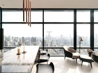 Modern living room with large windows offering a panoramic city view