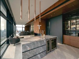 Modern living room with kitchen bar and cityscape view