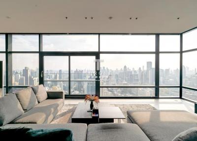 Spacious living room with large windows and city view