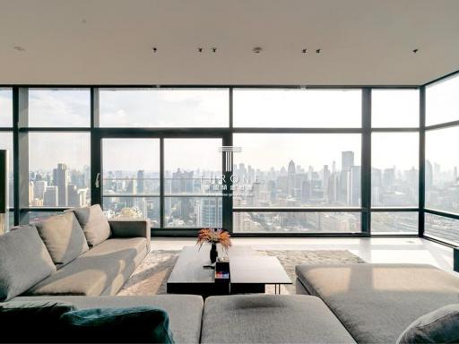 Spacious living room with large windows and city view