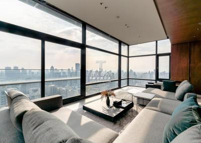 Modern living room with large windows offering a panoramic city view