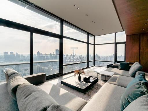 Modern living room with large windows offering a panoramic city view