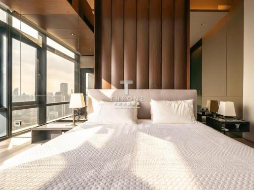 Modern bedroom with large bed and panoramic city view
