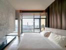 Modern bedroom with large bed and expansive city view