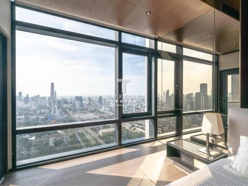 Spacious living room with floor-to-ceiling windows overlooking the city