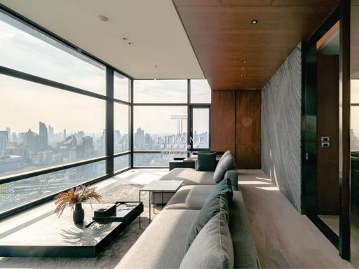 Modern living room with panoramic city view through floor-to-ceiling windows