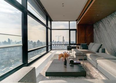 Modern living room with large windows and cityscape view