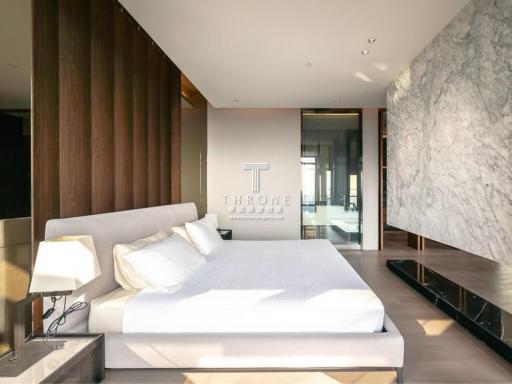 Modern bedroom with wooden accent wall and marble detailing