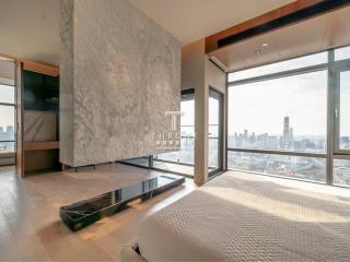 Spacious bedroom with large windows and city view