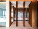 Modern office building lobby with glass doors and wood paneling