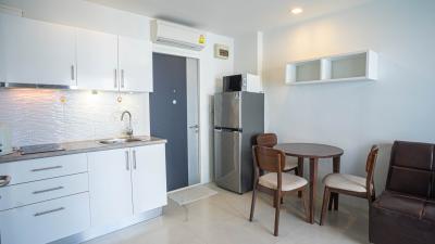 Compact kitchen with modern appliances and adjoining dining area