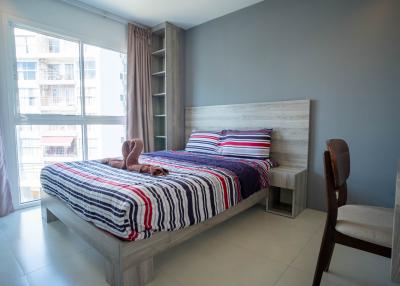 Modern bedroom with a view of the city