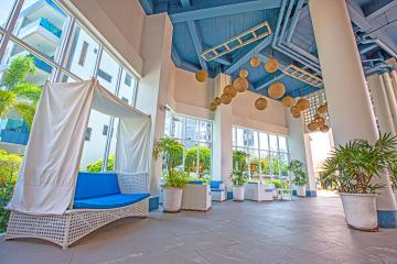 Modern building lobby with seating area and decorative pendant lights