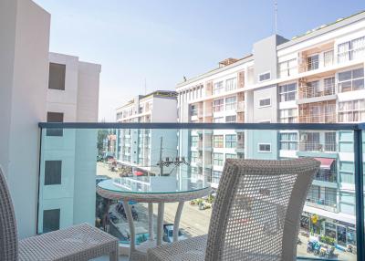 View from a balcony featuring outdoor furniture with a cityscape background