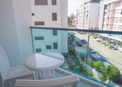 Cozy balcony with a table and chair overlooking the street