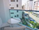 Cozy balcony with a table and chair overlooking the street