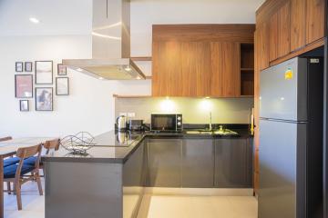 Modern kitchen with wooden cabinets and stainless steel appliances