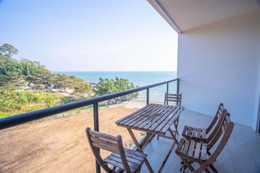 Spacious balcony with ocean view and outdoor seating