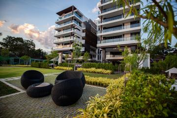 Modern apartment buildings with landscaped garden and outdoor seating