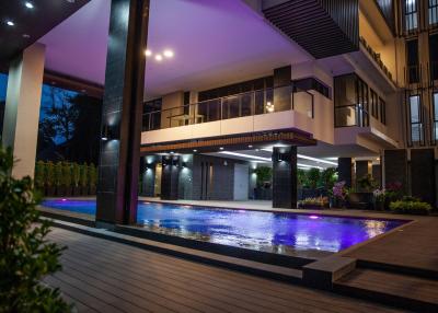 Modern luxury house exterior with swimming pool at twilight