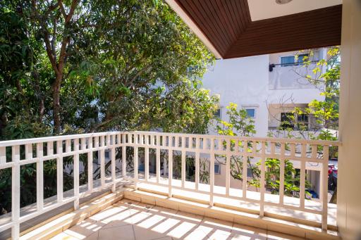 Spacious balcony with natural light and garden view