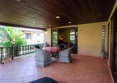 Spacious balcony with outdoor seating and garden view