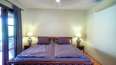 Cozy bedroom with wooden bed frame and natural light