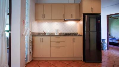 Compact modern kitchen with terracotta tiles and updated appliances