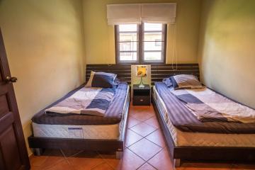 Cozy twin bedroom with terracotta floor tiles
