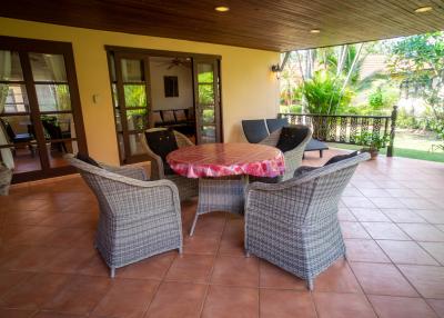 Spacious patio with outdoor dining set and sliding doors leading to the interior
