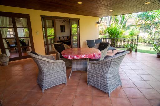 Spacious patio with outdoor dining set and sliding doors leading to the interior