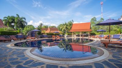 Luxurious resort-style outdoor swimming pool with lounge chairs and umbrellas