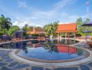 Luxurious resort-style outdoor swimming pool with lounge chairs and umbrellas