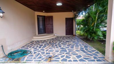 Front porch of a house showing entrance doors, exterior lighting, and tiled floor