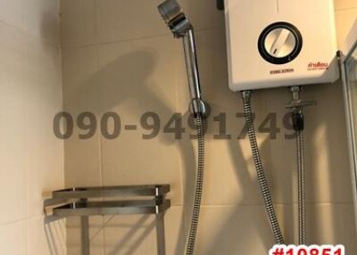 Modern bathroom wall with water heater and shower