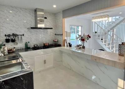 Modern kitchen with marble countertops and stainless steel appliances